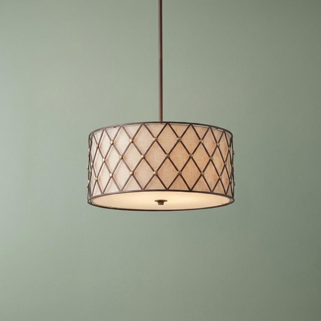 Drum pendant light featuring a brown metal lattice frame over a beige fabric shade against a green wall.