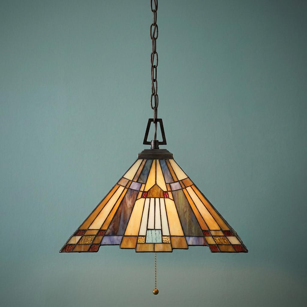 Geometric Tiffany-style pendant light with amber and blue stained glass shade hanging against a plain blue wall.
