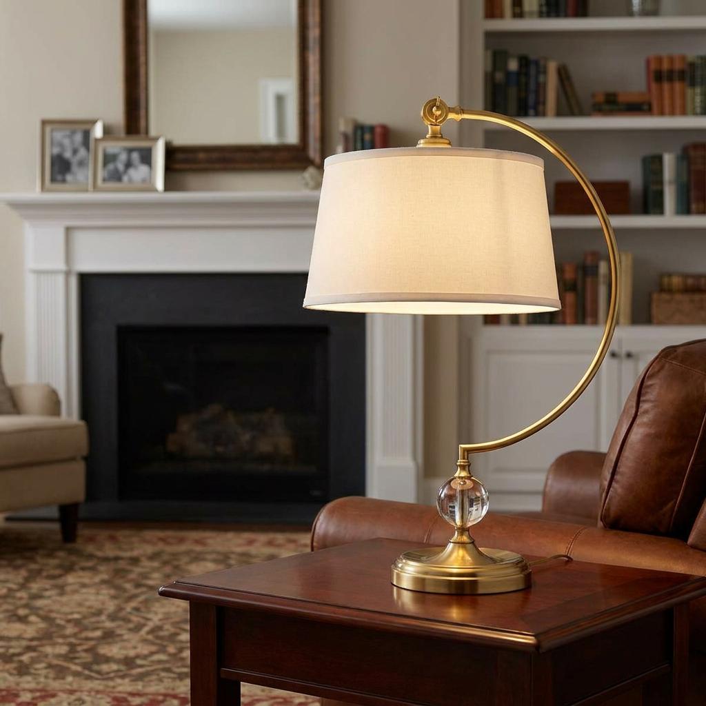 Quoizel Jenkins brass table lamp with cream shade on a wooden side table in a cozy living room.