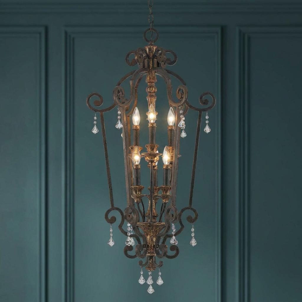 Quoizel Marquette 6 Light Gold Heirloom Chandelier with crystal drops against a teal paneled wall.