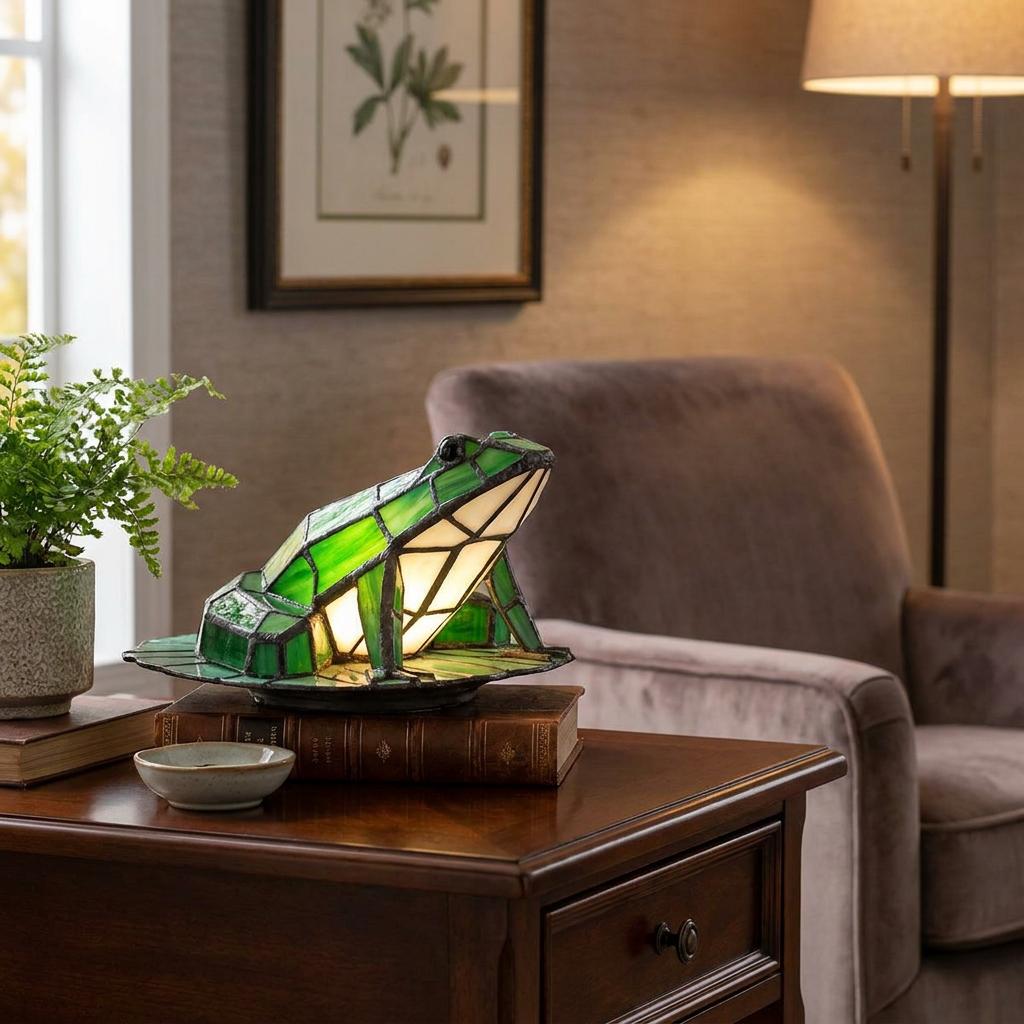 Green stained-glass frog lamp glowing on a wooden end table next to a plush armchair in a living room.