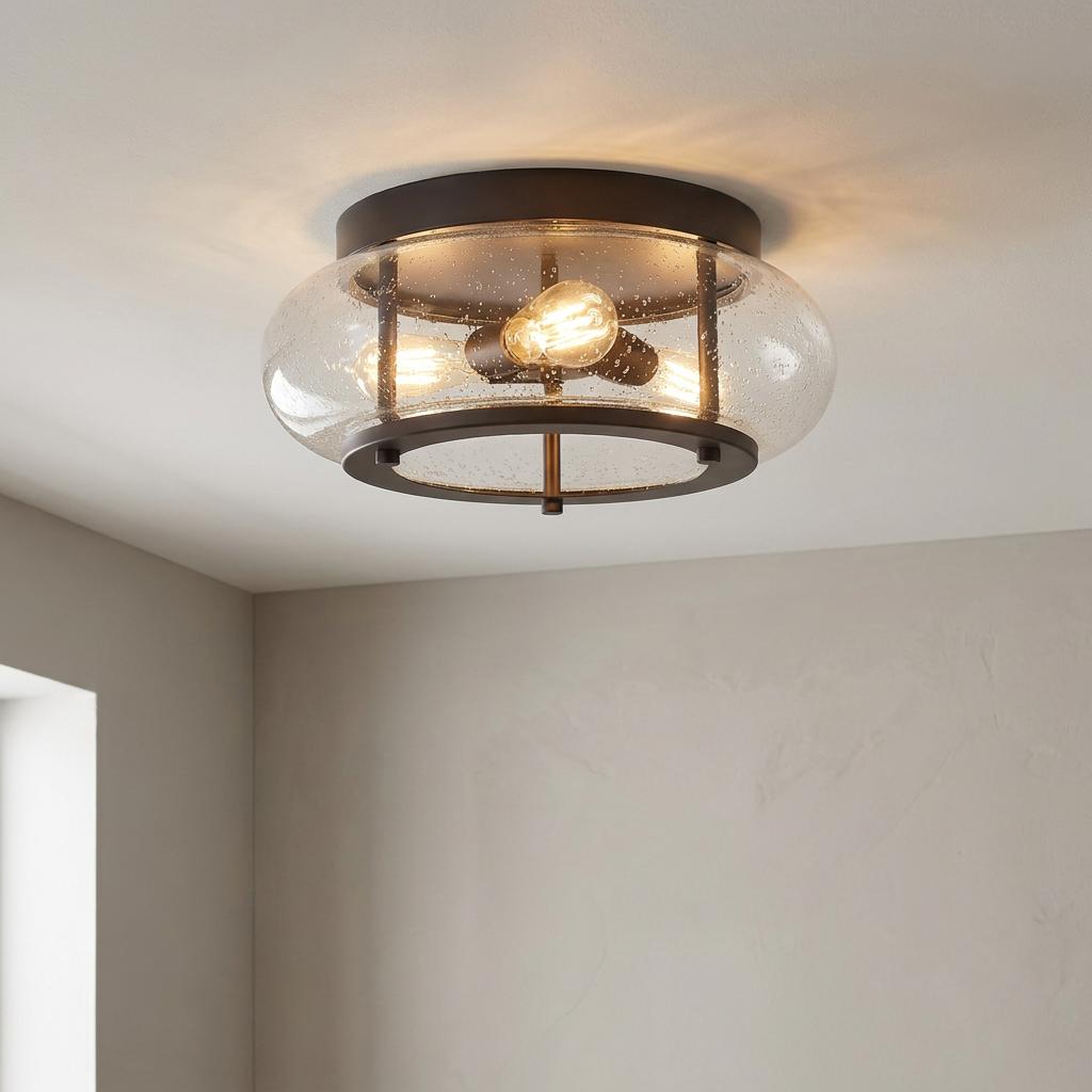 Quoizel Trilogy old bronze flush ceiling light featuring a clear seeded glass shade and vintage-style bulbs.