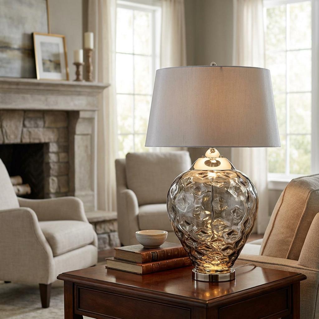 Samara Large Smoked Glass Table Lamp with a textured base and grey shade on a dark wood table in a living room.