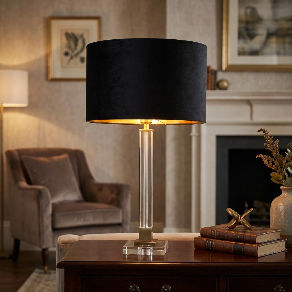 Scarborough table lamp featuring a fluted crystal column, brass accents, and a black velvet drum shade.