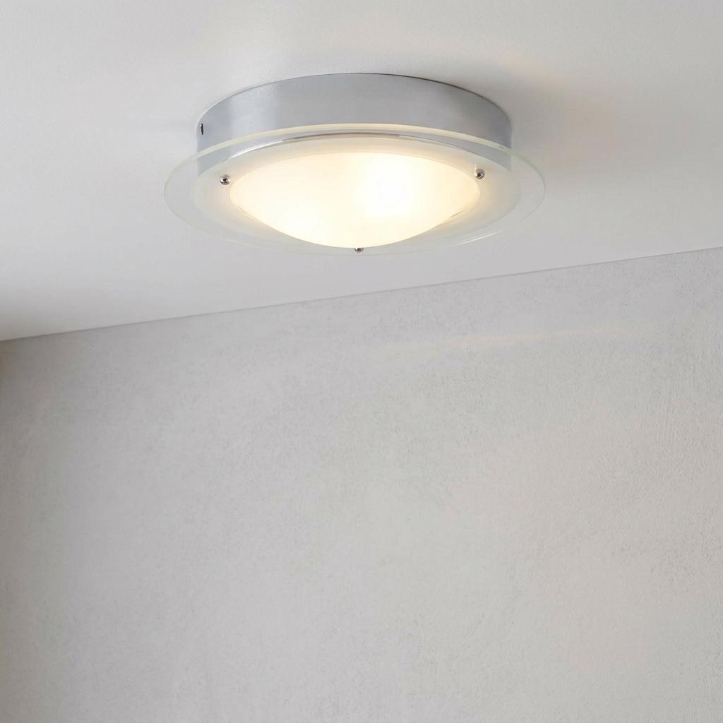 Chrome flush bathroom ceiling light with a clear glass ring and glowing frosted glass dome.