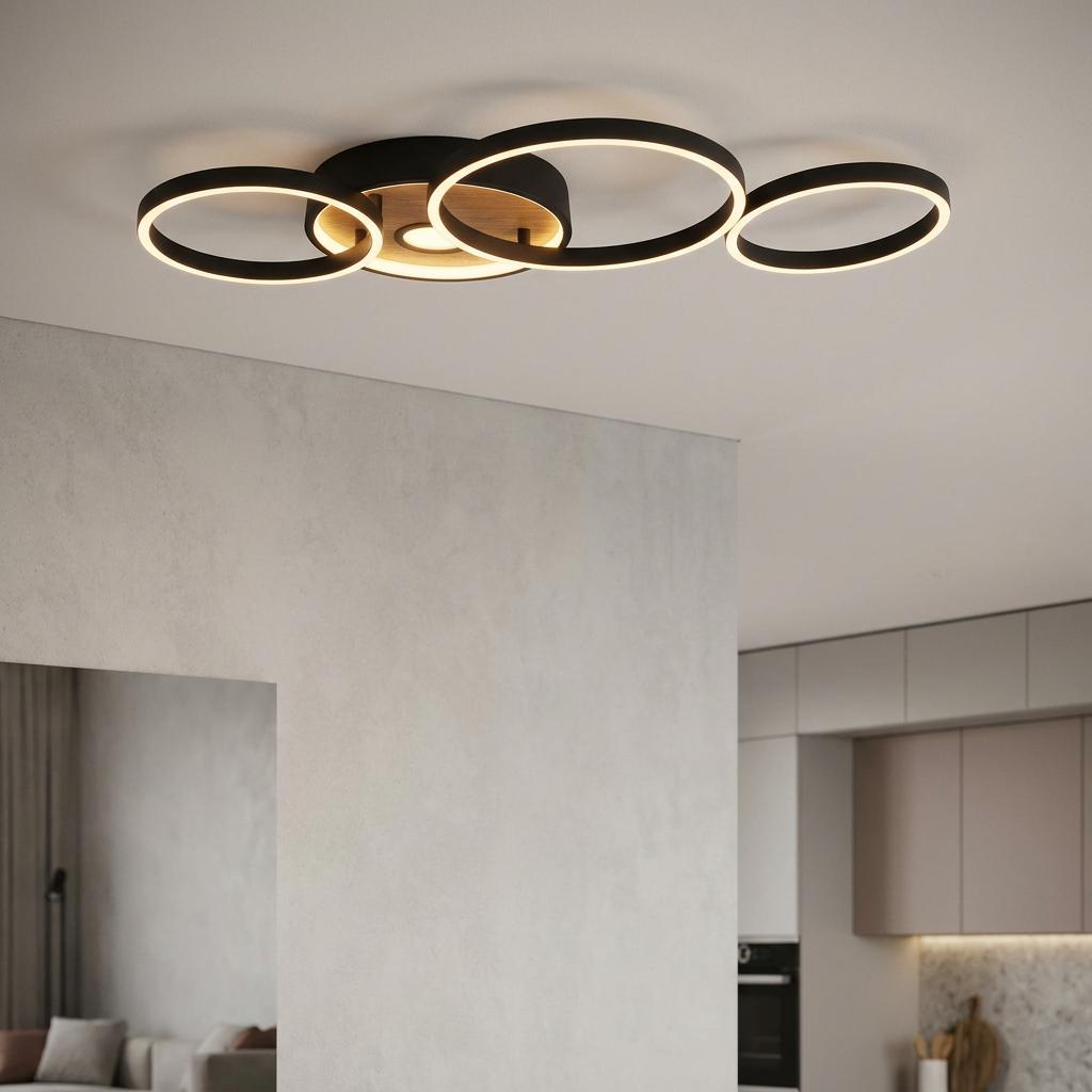 Modern LED ceiling light with four overlapping black and wood rings illuminated in a contemporary interior.