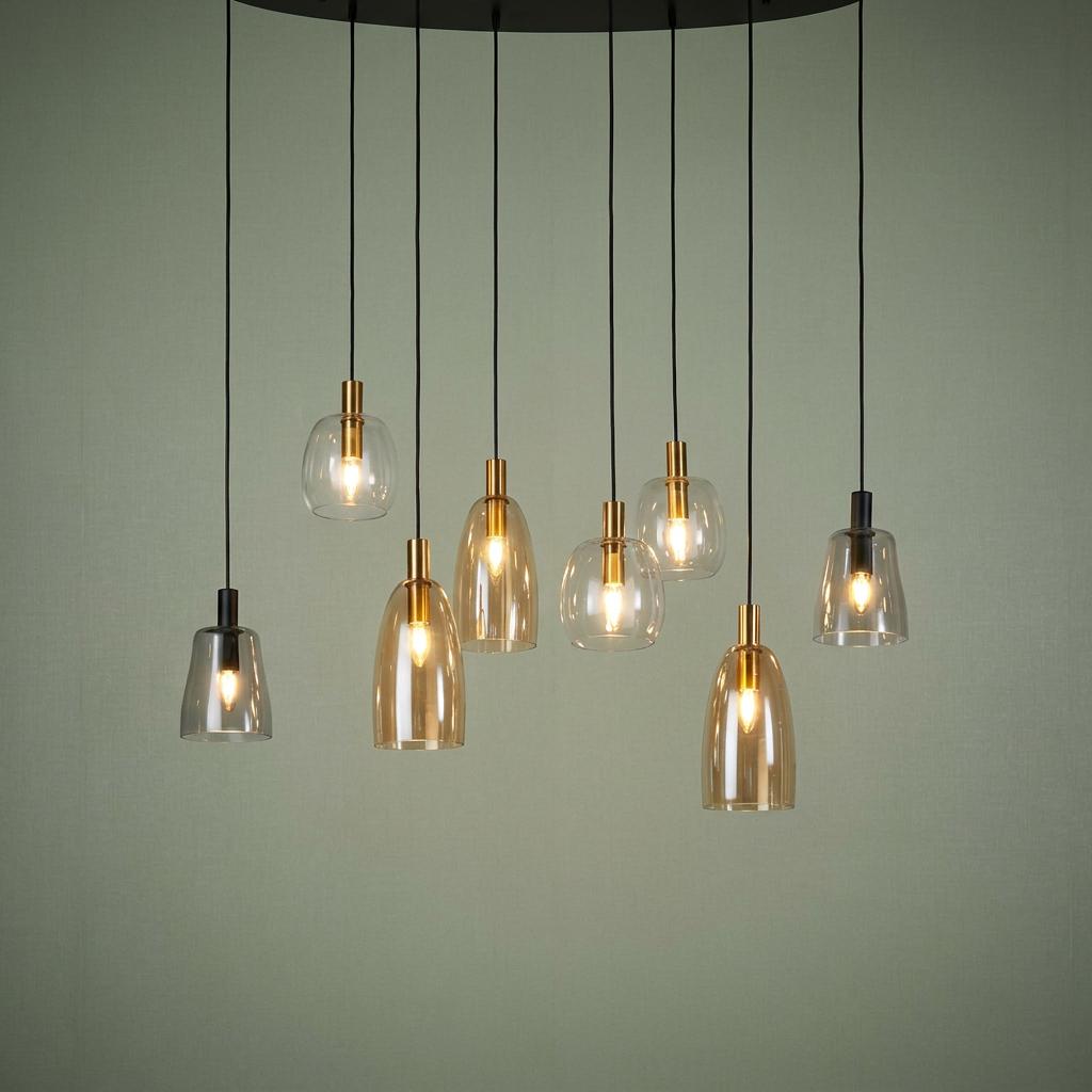 Staggered eight-light multi-drop pendant featuring assorted amber and smoked glass shades against a green wall.