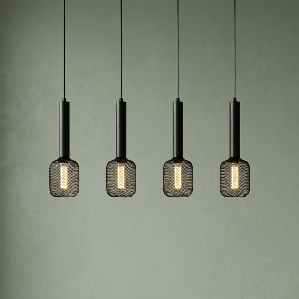 Four black pendant lights with cylindrical stems and mesh shades hanging against a pale green wall.