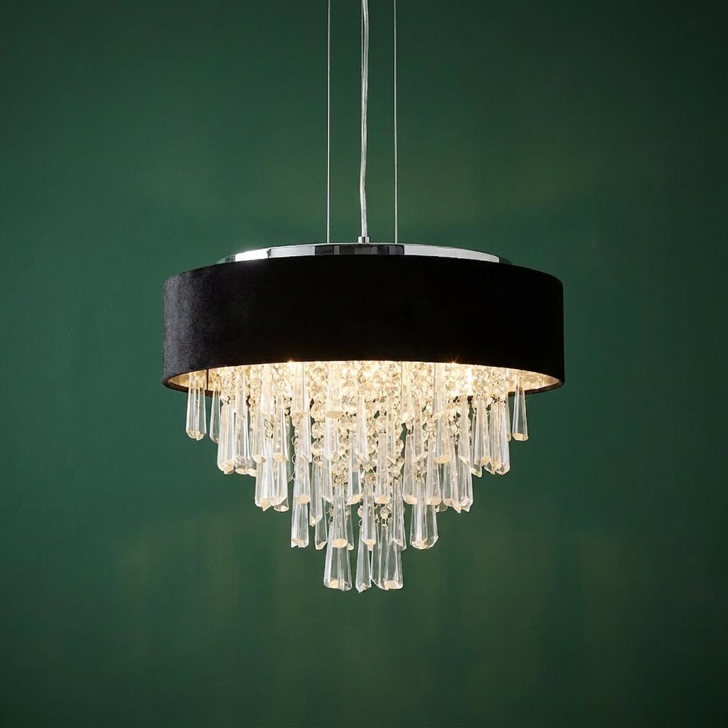 Black velvet pendant light with cascading clear crystal drops against a dark green background.