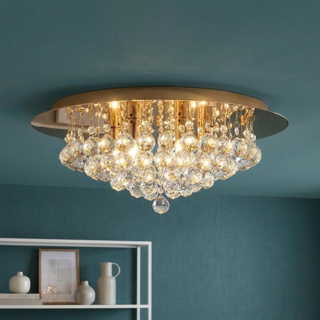 Gold 6-light flush ceiling fitting with cascading clear crystal balls mounted on a teal ceiling.