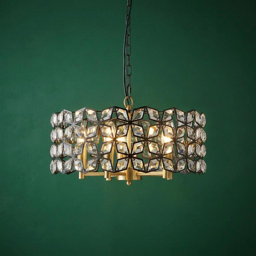 A 5-light pendant lamp with a black geometric crystal frame and brass accents against a dark green wall.