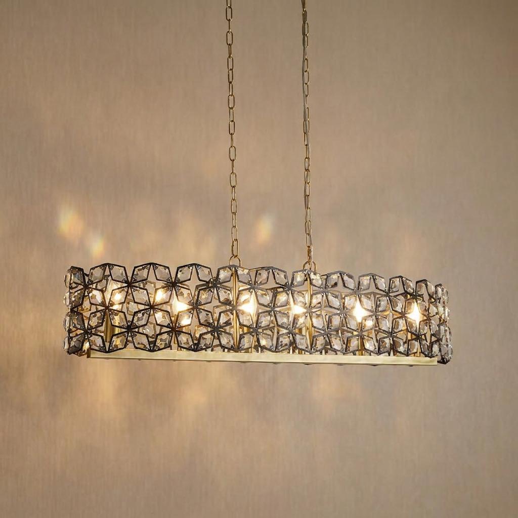 Modern rectangular pendant light featuring black geometric metalwork and faceted crystals with brass accents.