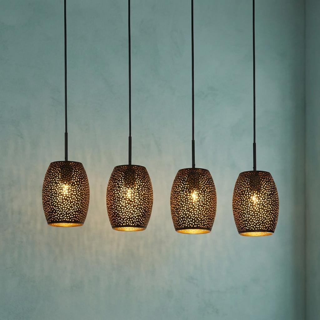 Four black laser-cut pendant lights with gold interiors hanging in a row against a textured blue wall.