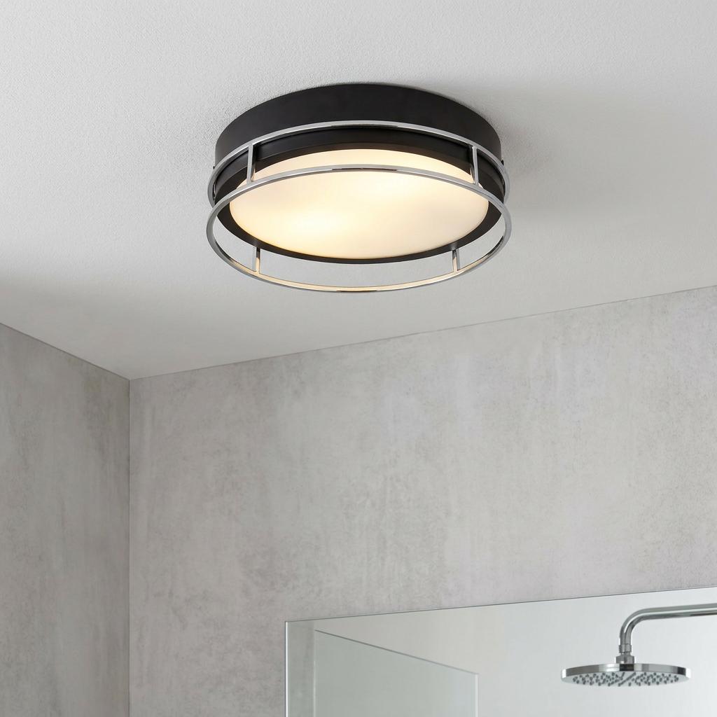 Modern black and chrome flush ceiling light with a metal cage and frosted diffuser mounted in a bathroom.