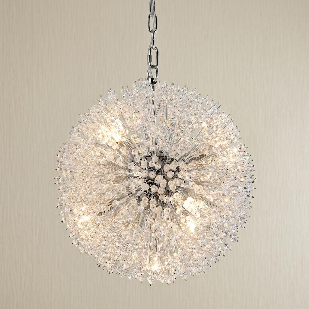 Spherical sunburst chandelier with chrome arms and clear glass beads, illuminated against a neutral wall.