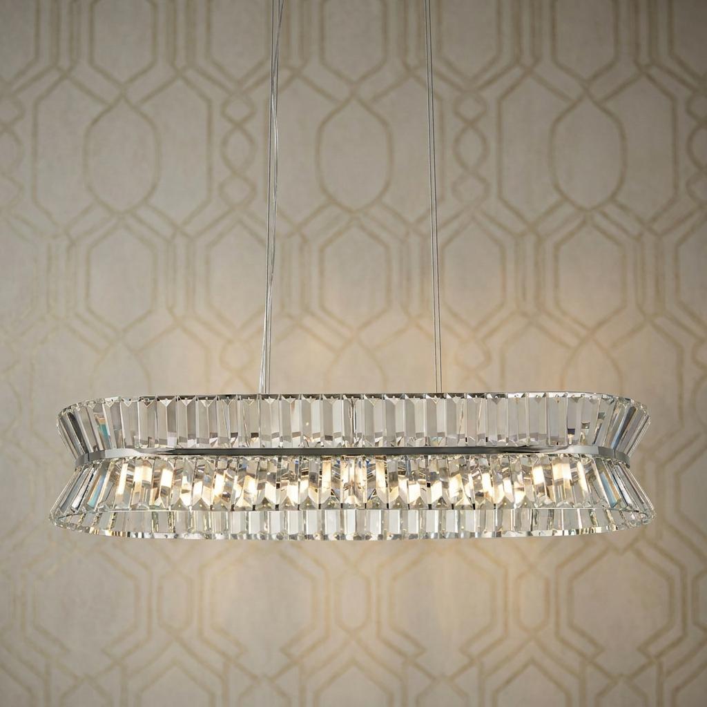 Searchlight Uptown oval chrome and crystal pendant light glowing against a geometric wallpaper.