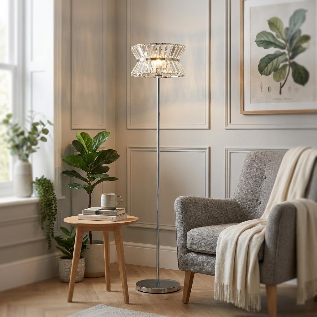 A chrome floor lamp with a crystal hourglass shade stands next to a grey armchair in a well-lit living room.
