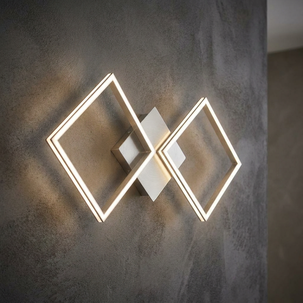 Modern silver wall light with two interlocking glowing square LED frames mounted on a textured grey wall.