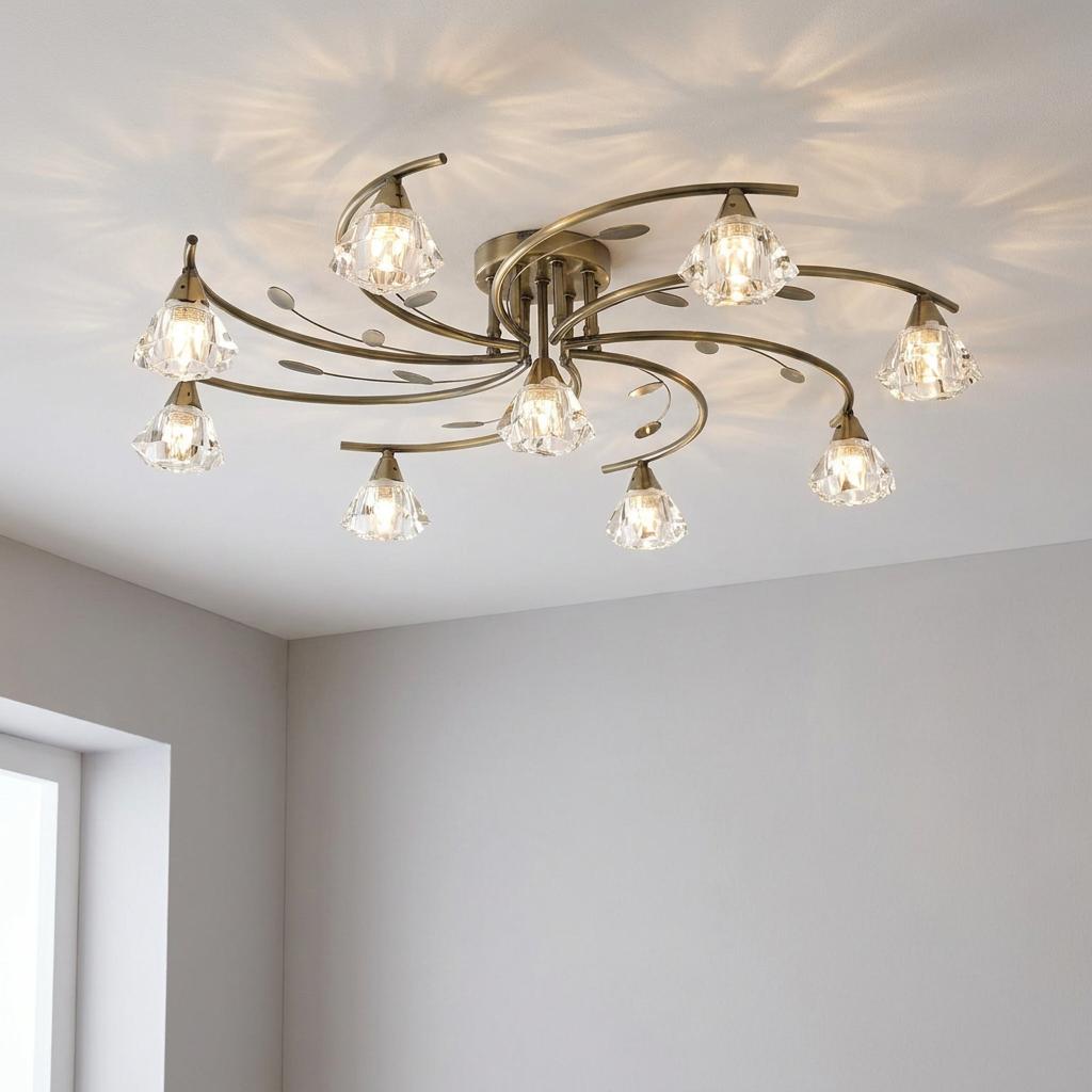 A 9-light antique brass semi-flush ceiling light with curved arms and clear crystal-like glass shades.
