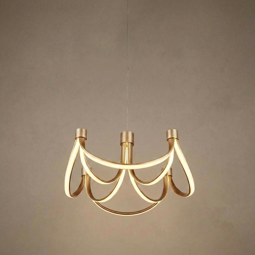 A gold 8-arm LED pendant light with looping ribbon-like arms hanging against a textured neutral wall.