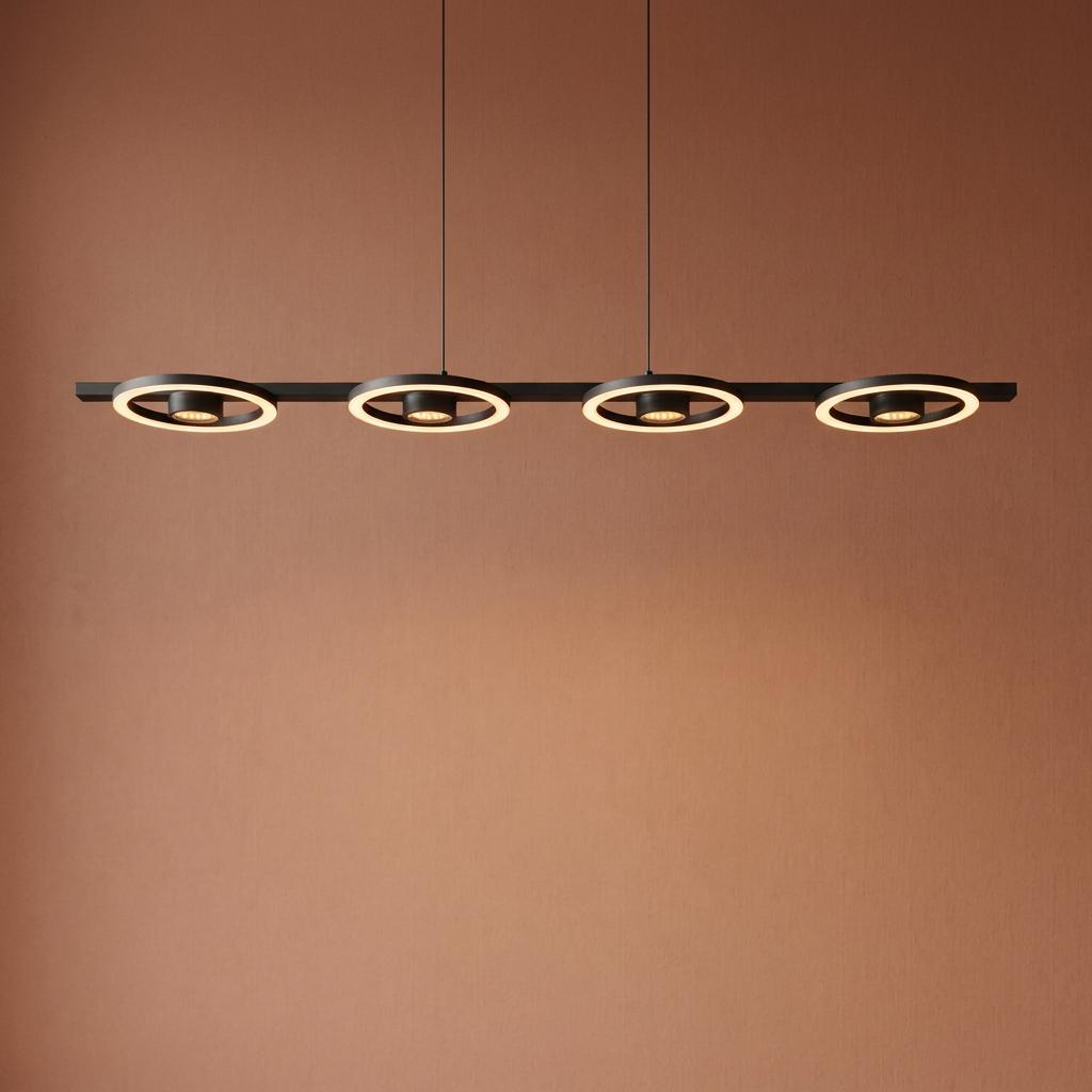 Four-ring black metal linear pendant light with integrated LEDs suspended against a terracotta wall.