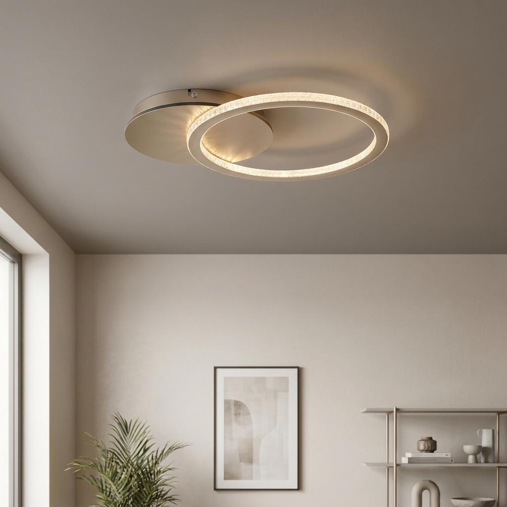 Modern flush LED ceiling light featuring glowing interlocking rings in champagne finish on a beige ceiling.