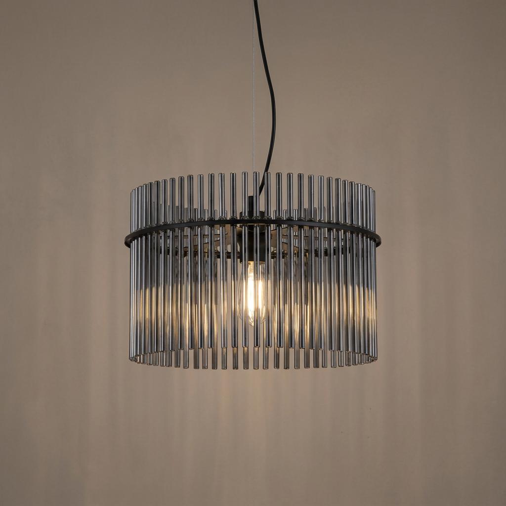 Matt black pendant light featuring a drum-shaped shade of smoked glass rods, illuminated against a neutral background.