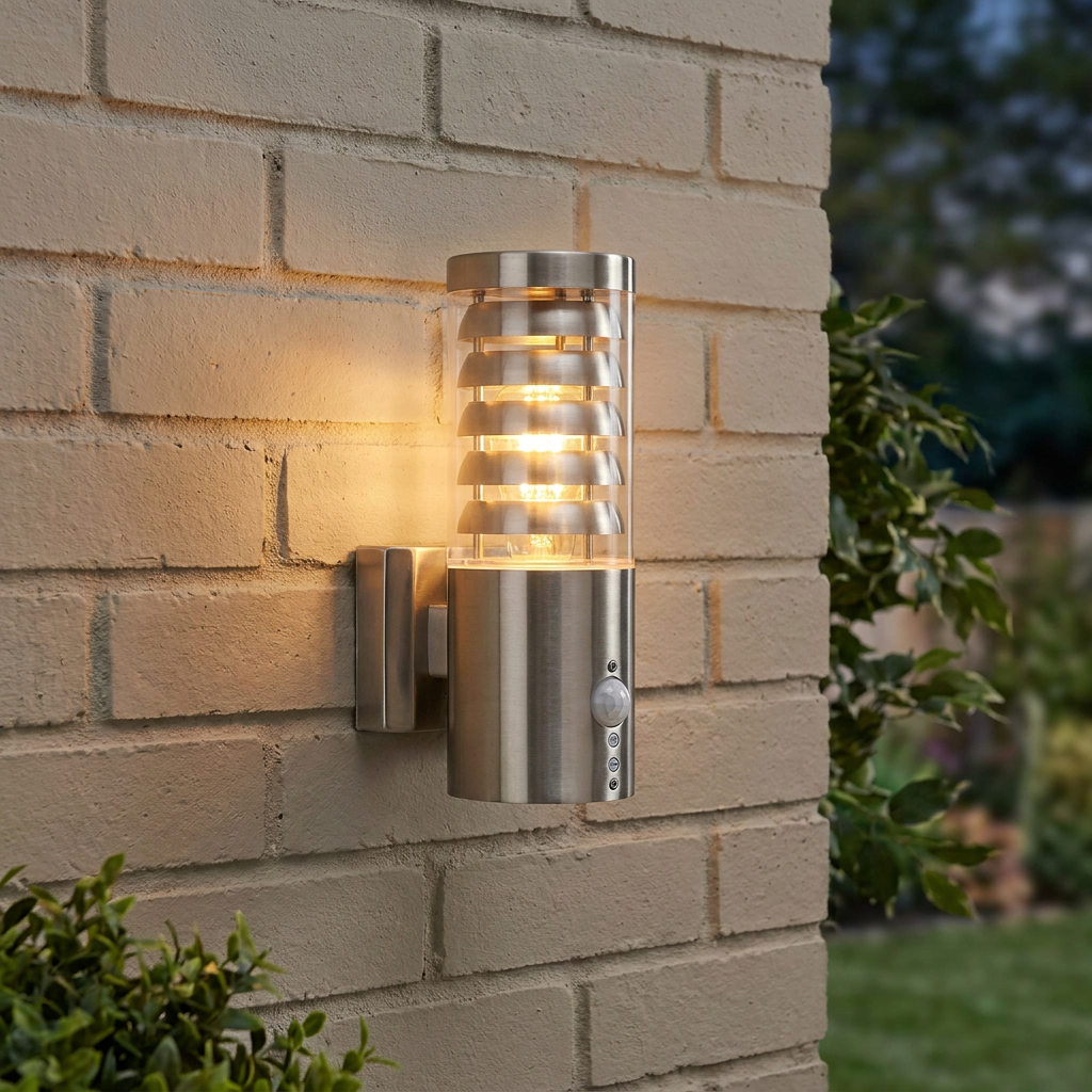Stainless steel outdoor wall light with tiered slats and PIR sensor, glowing warmly on a light brick wall.