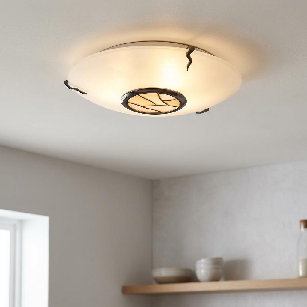 Tiffany-style flush mount ceiling light with beige glass and decorative dark metal accents, lit on a white ceiling.