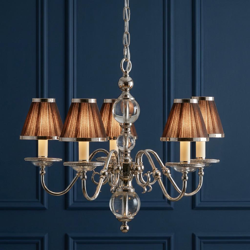 Polished nickel 5-light chandelier with chocolate brown pleated shades against a navy blue paneled wall.