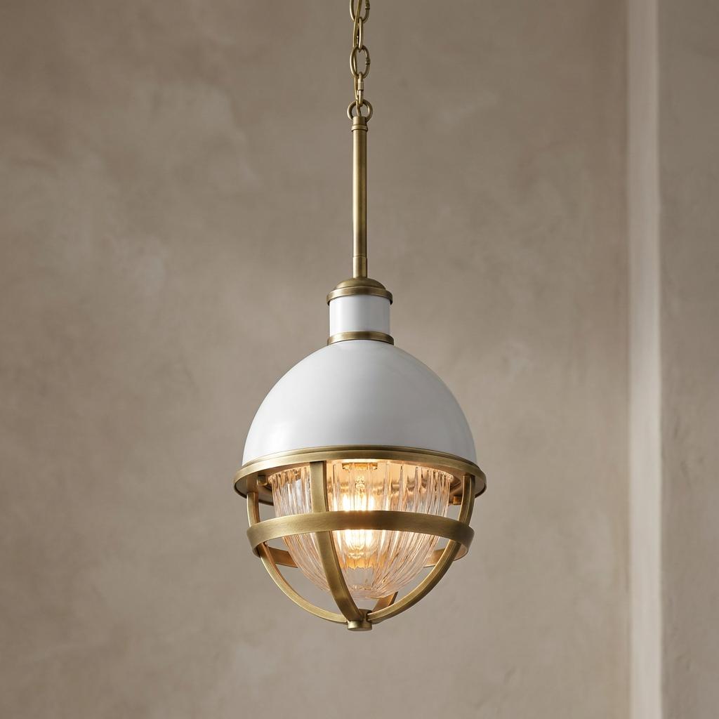 White and brass pendant light with a caged ribbed glass shade illuminated against a neutral background.