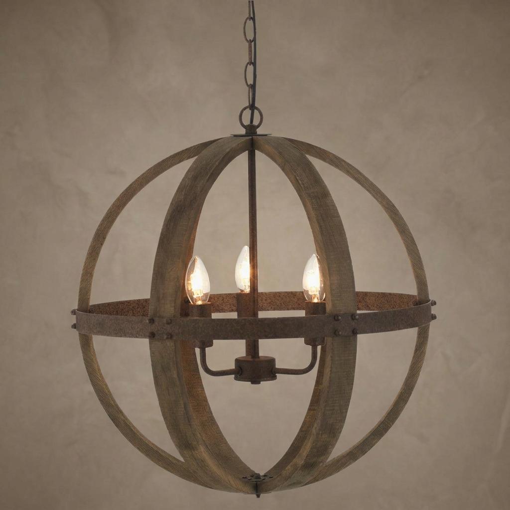 Spherical pendant light featuring wooden arches, a rusty metal band, and three glowing candle bulbs.