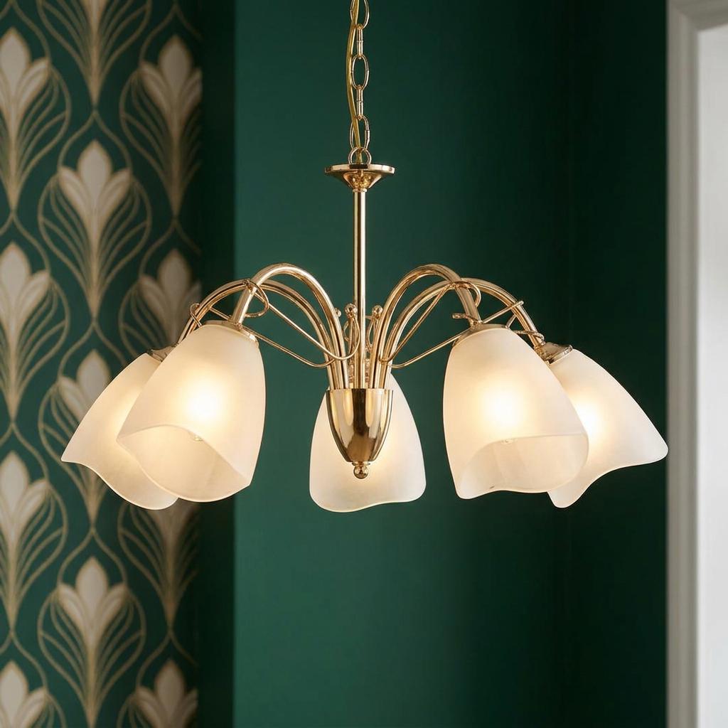 Turin Polished Brass 5 Light Chandelier with frosted tulip shades against a dark green Art Deco wallpaper.
