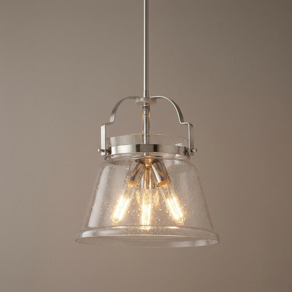 Wimberley 3 light pendant in polished chrome featuring a seeded glass shade and three glowing vintage-style bulbs.