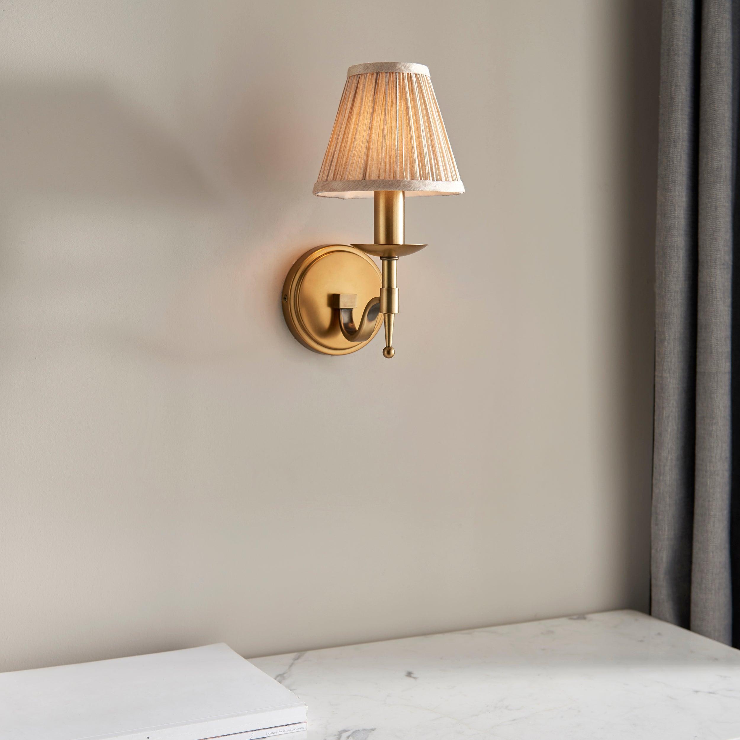 stanford brass single wall light with beige shade Living room lighting image