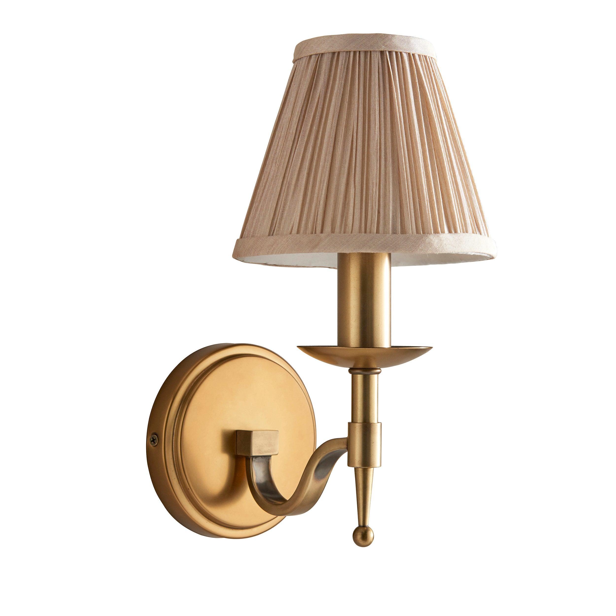 stanford brass single wall light with beige shade Bedroom Lighting lit image