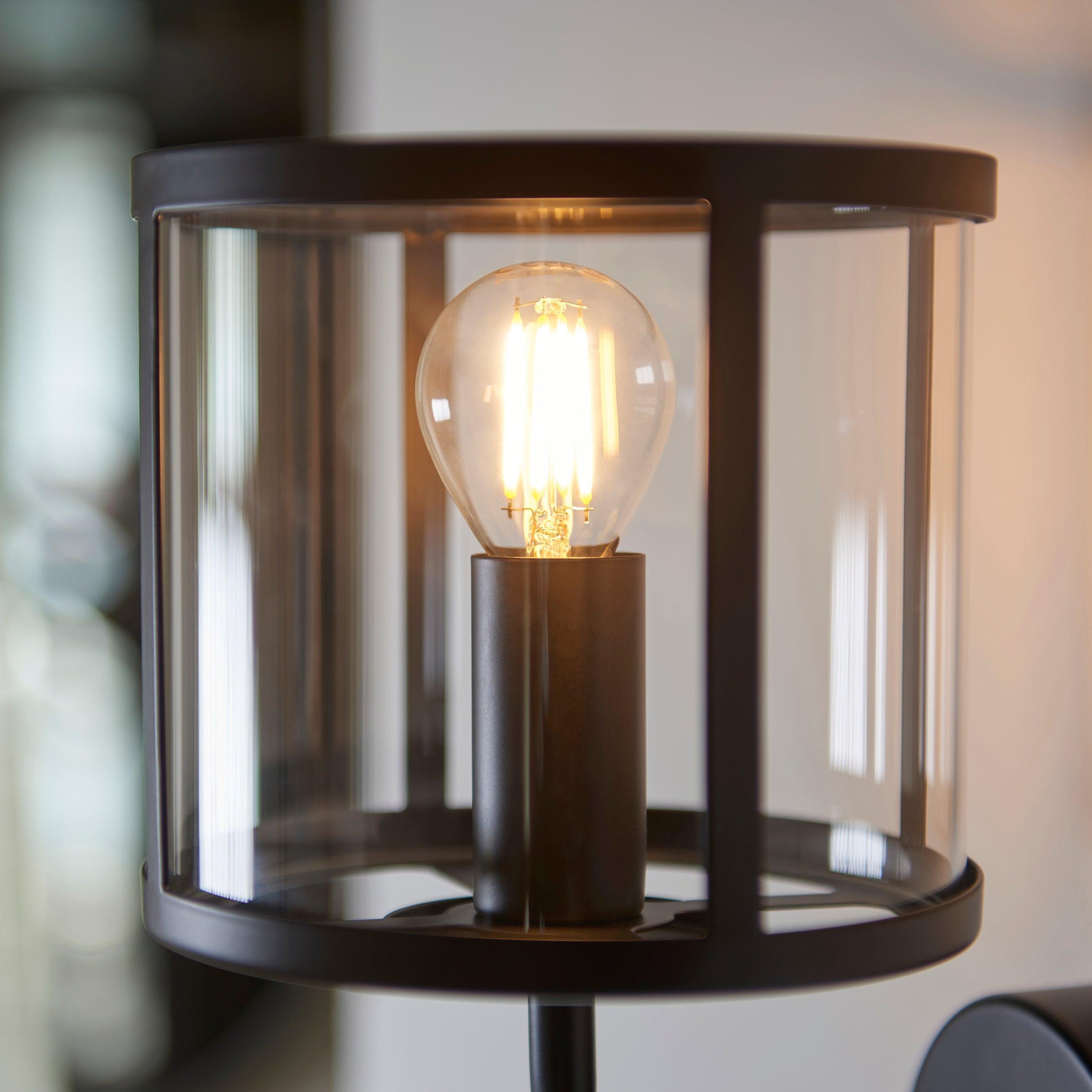 hopton black wall light clear glass shade by Endon Lighting Bedroom Close Up Image
