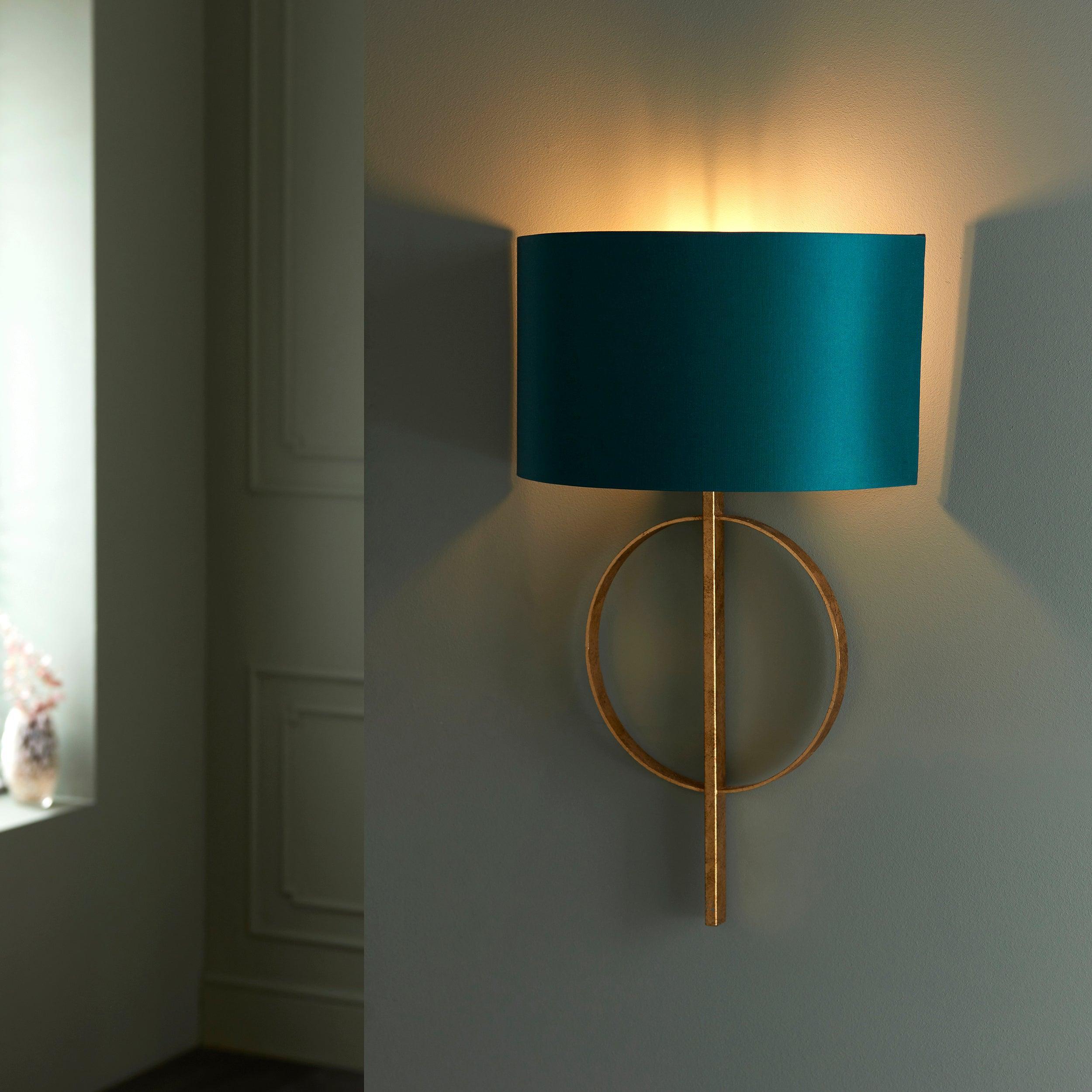 norfolk gold wall light with teal half shade Living room close up image
