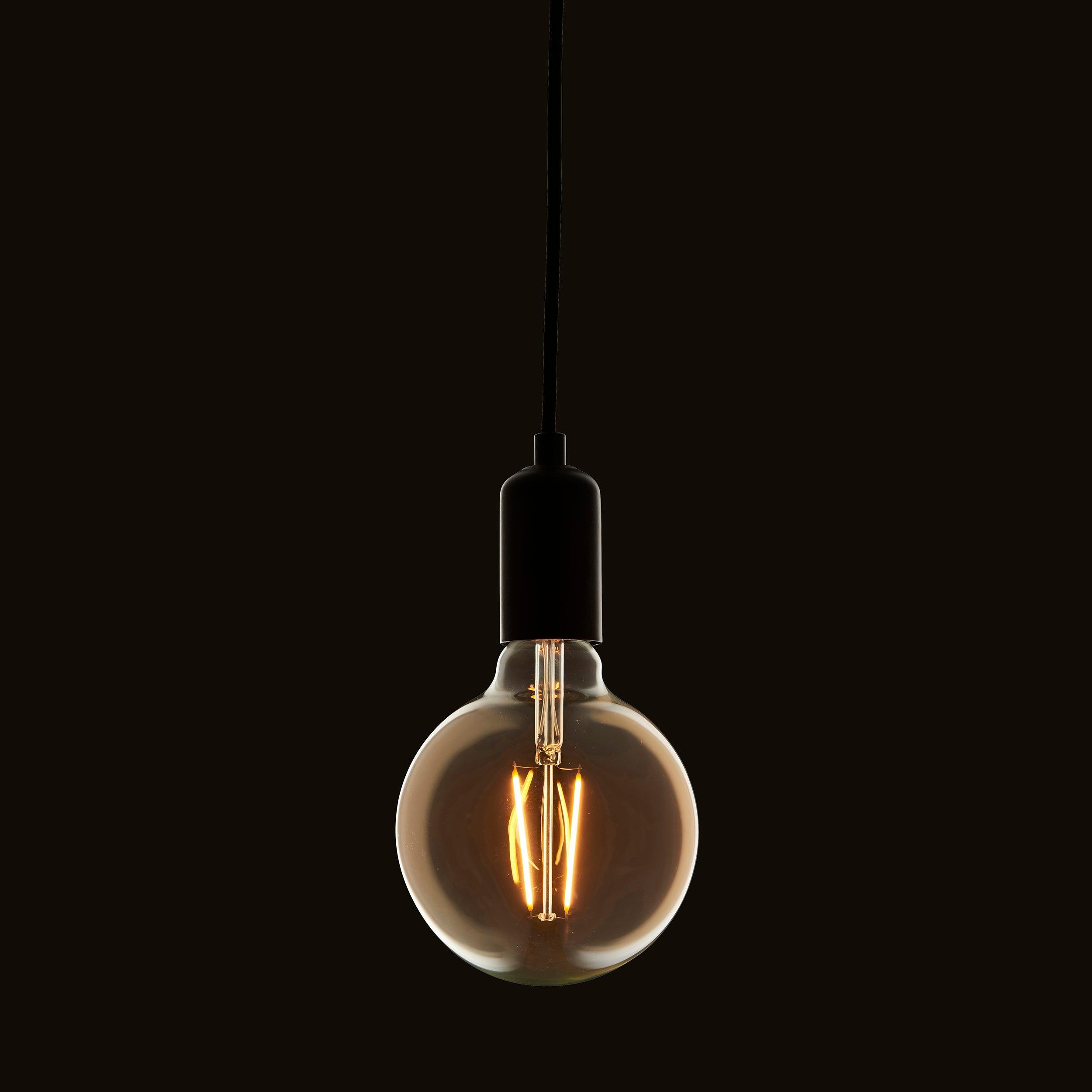 e27 led 2w 125mm dia tinted amber filament globe light bulb Close Up Lit Image