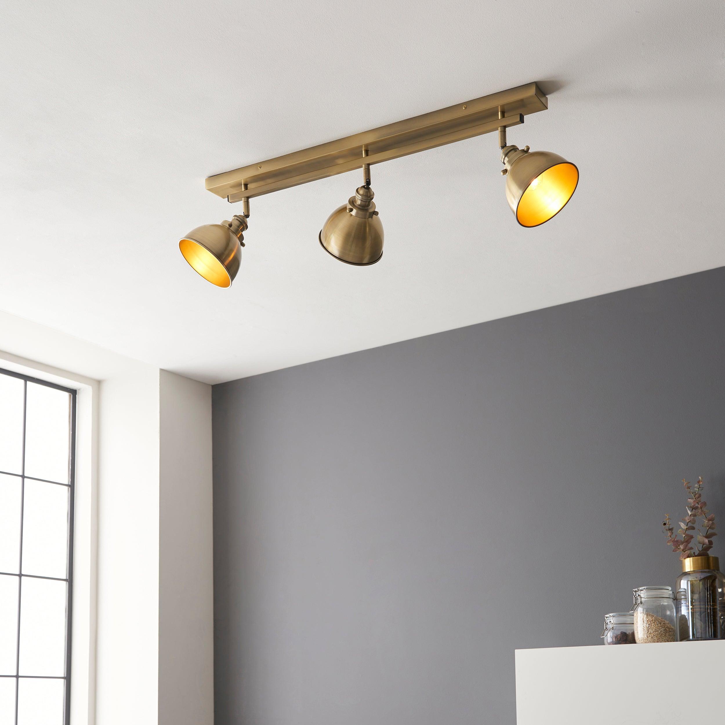 wyatt 3 light brass industrial spot light by Endon Lighting Living room close up image