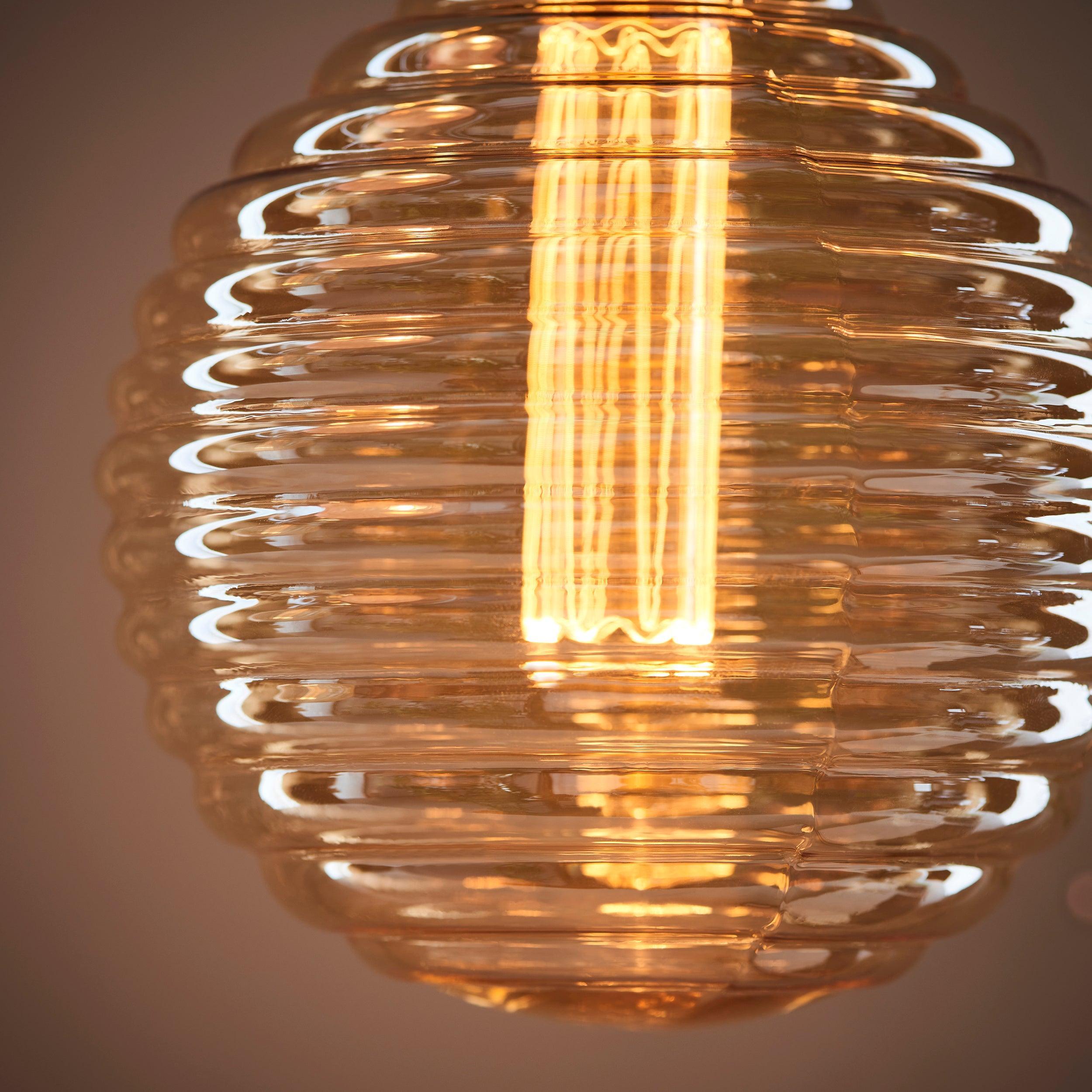 beehive e27 amber tinted ribbed 2 5w led light bulb Close Up Lit Image
