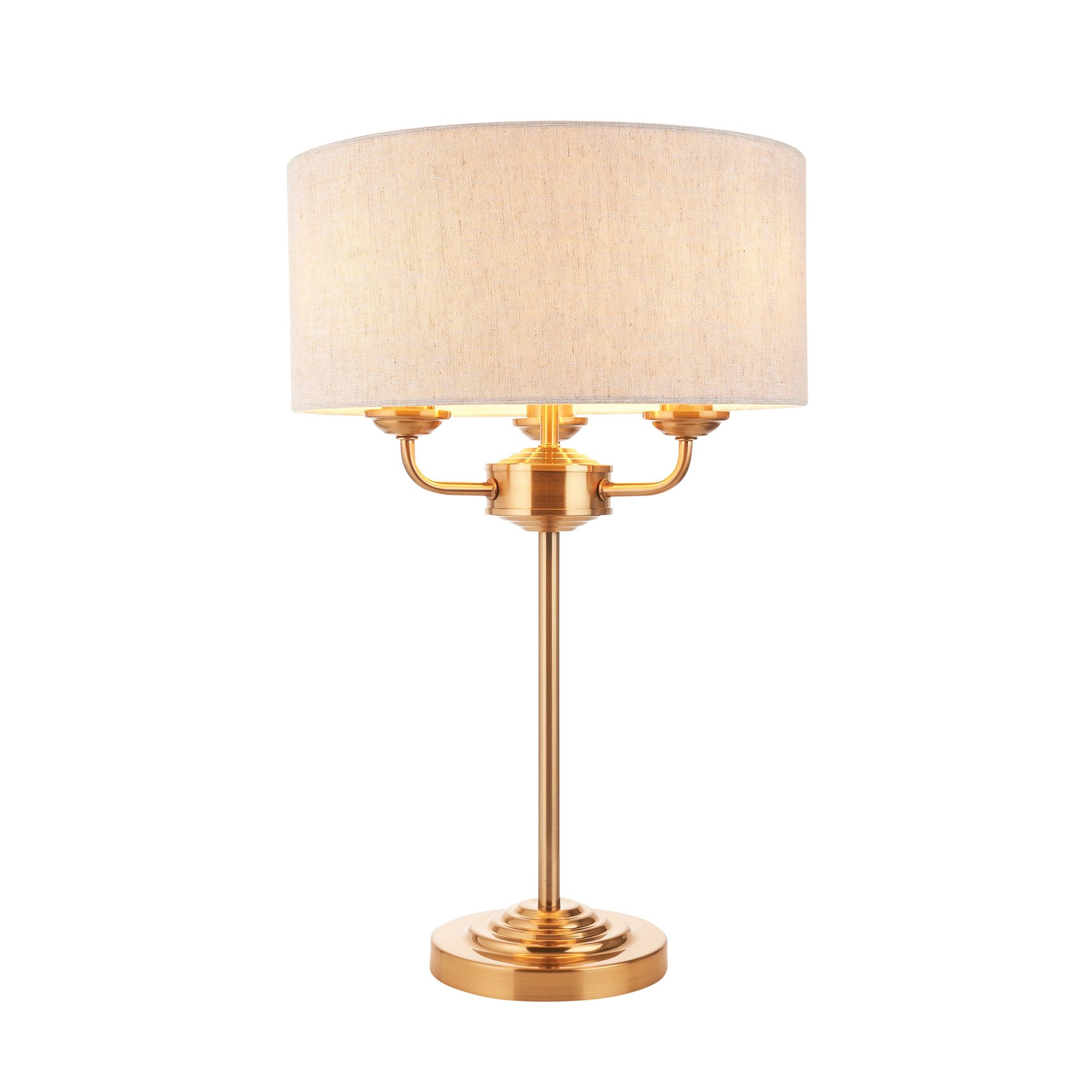 highclere vintage brass 3 light table lamp linen shade by Endon Lighting Living room close up image