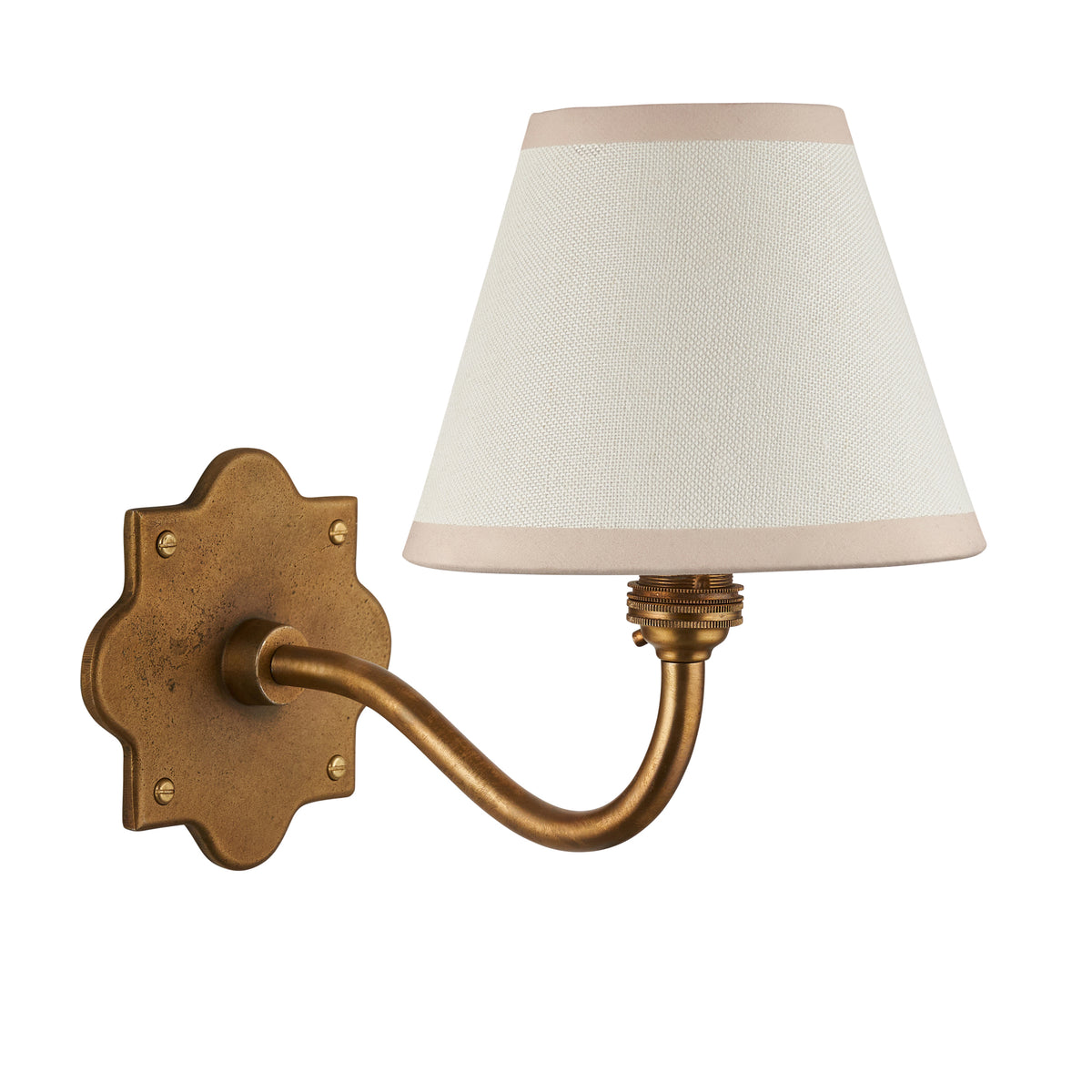 Anvil Curve antique brass wall light with cream fabric shade and gently curving arm on a plain background