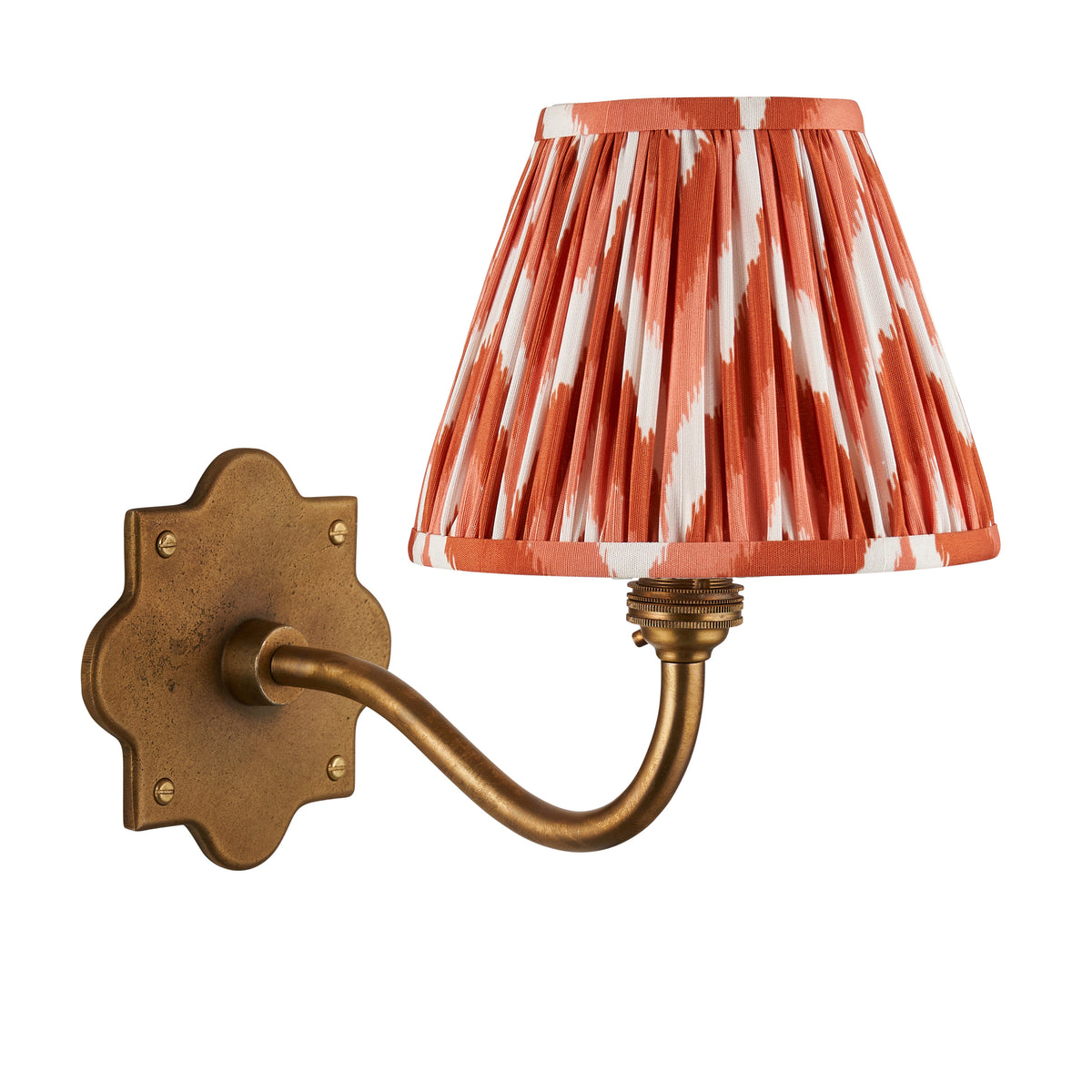 Anvil Curve antique brass wall light with orange zigzag ikat shade, plain studio product shot