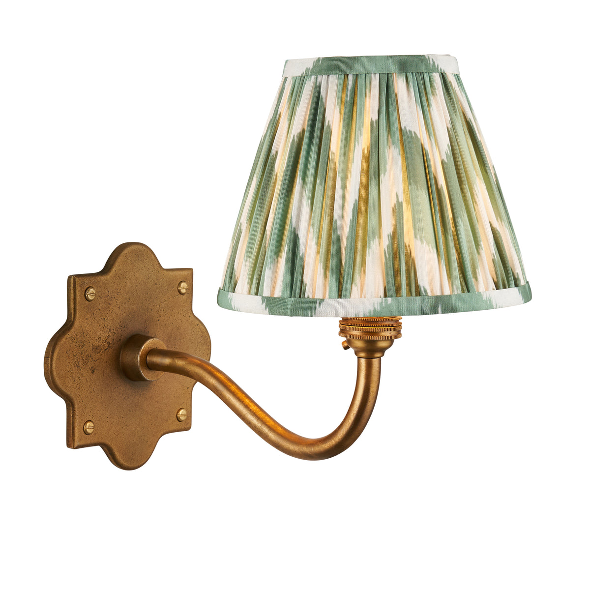 Anvil Curve antique brass wall light with green zigzag ikat pleated shade on a white background