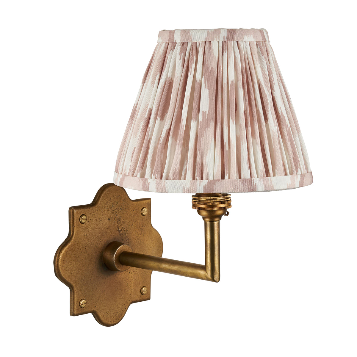 Anvil Angle antique brass wall light with blush-toned pleated ikat shade, plain studio shot