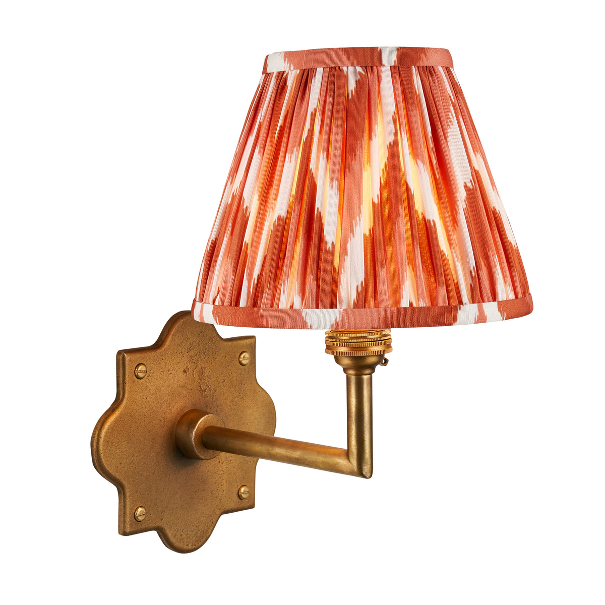 Anvil Angle antique brass wall light with orange zigzag ikat pleated shade on a white background