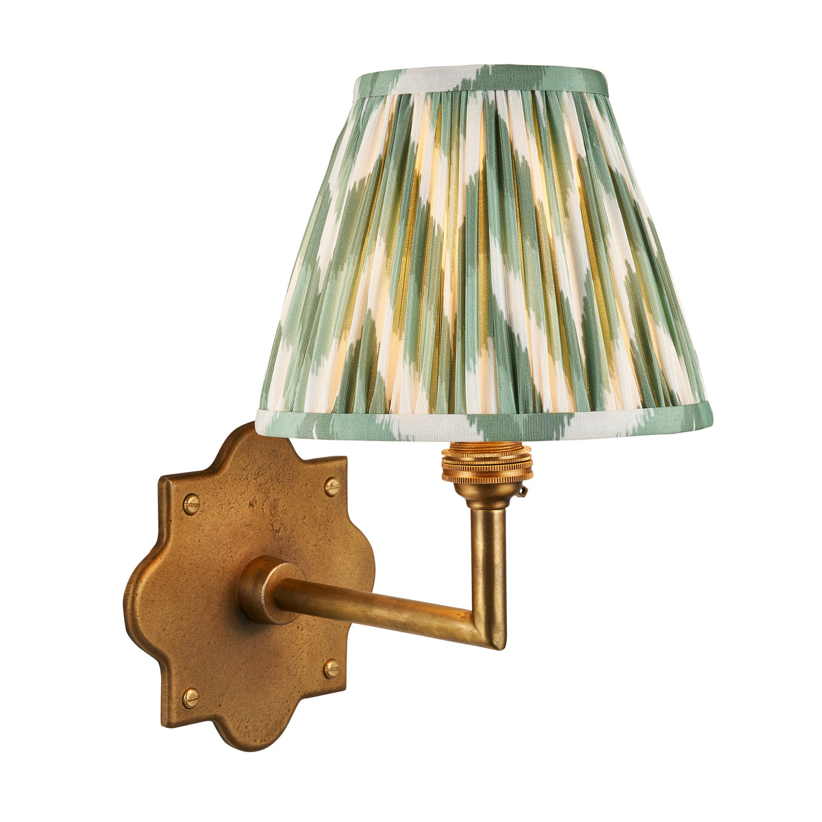 Anvil Angle brass wall light with green and cream ikat pleated shade on a shaped backplate