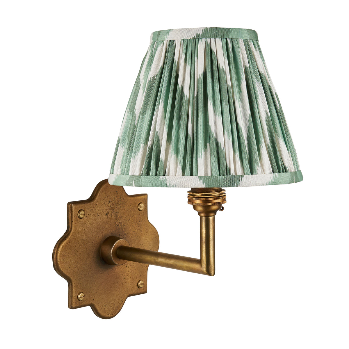 Anvil Angle brass wall light with green ikat pleated shade, cut out on a white background