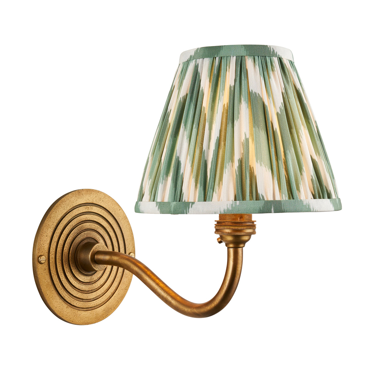 Ripple Curve antique brass wall light with green zigzag ikat pleated shade and ribbed round backplate